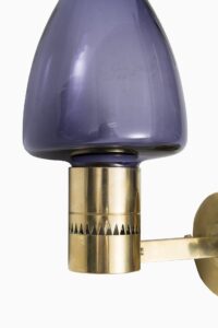 Hans-Agne Jakobsson wall lamps in brass and purple glass at Studio Schalling