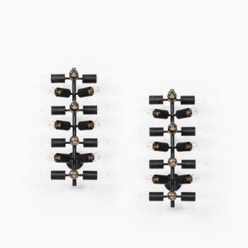 A pair of wall lamps in black lacquered metal at Studio Schalling