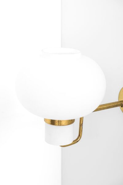 Wall lamps in brass and opaline glass at Studio Schalling