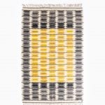 Ingrid Dessau carpet in grey and yellow at Studio Schalling