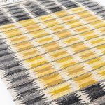 Ingrid Dessau carpet in grey and yellow at Studio Schalling