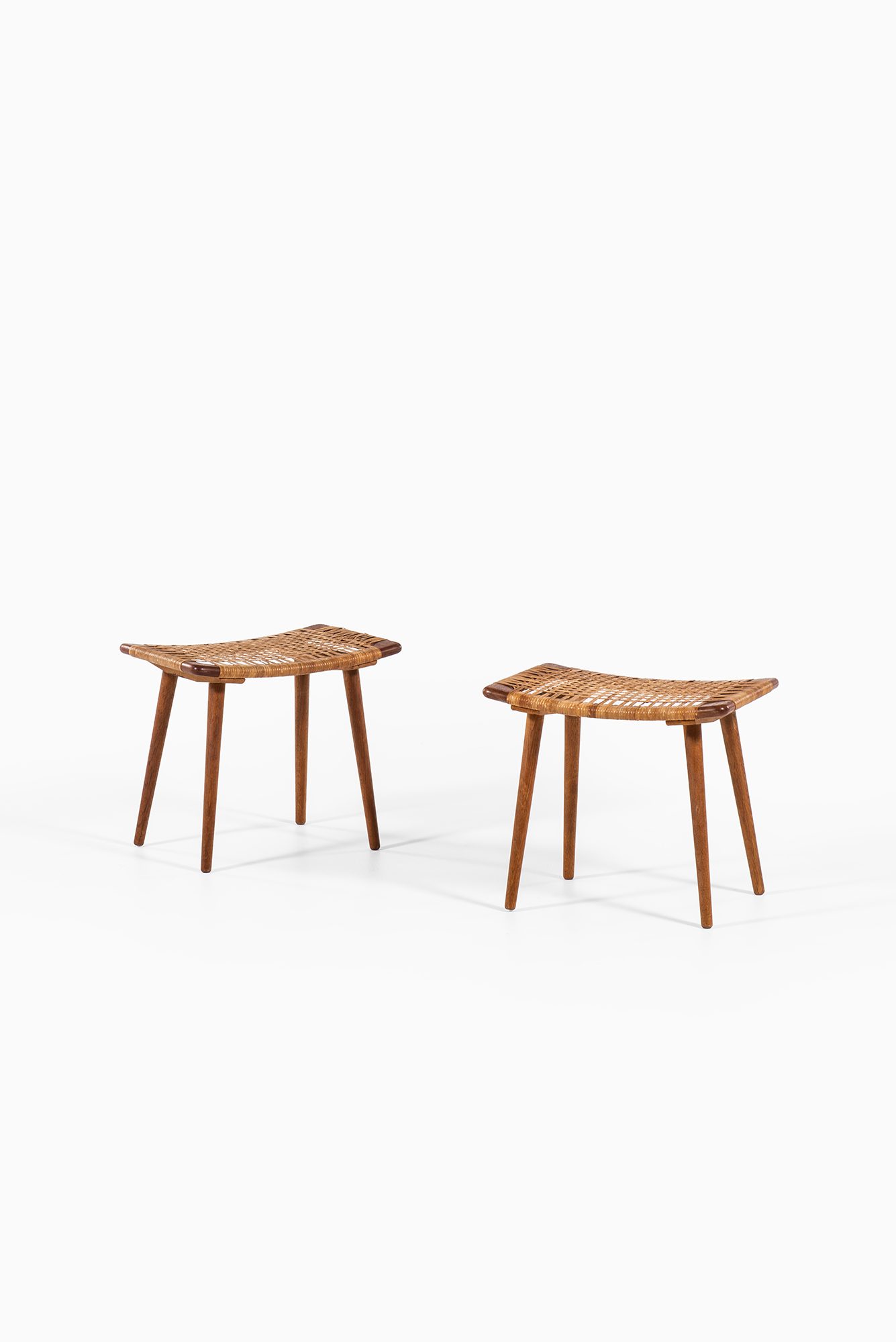 A pair of stools in oak and woven cane at Studio Schalling