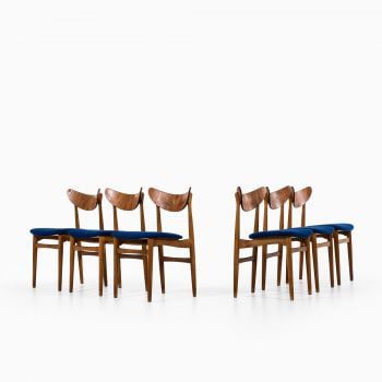 Dining chairs in oak, teak and blue fabric at Studio Schalling