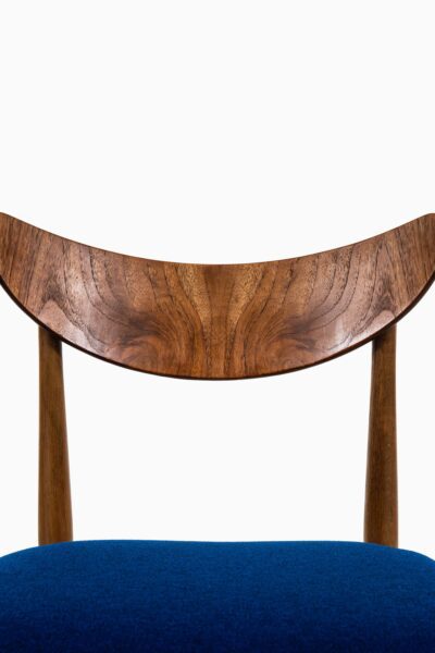 Dining chairs in oak, teak and blue fabric at Studio Schalling