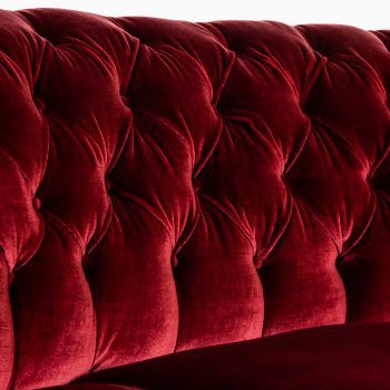 Large freestanding curved sofa in red velvet at Studio Schalling