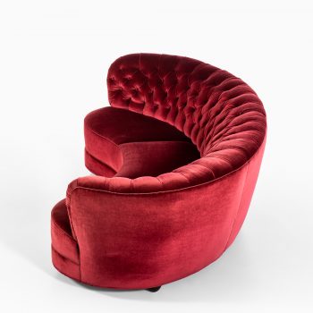 Large freestanding curved sofa in red velvet at Studio Schalling