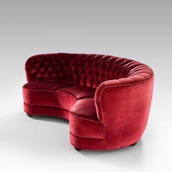 Large freestanding curved sofa in red velvet at Studio Schalling