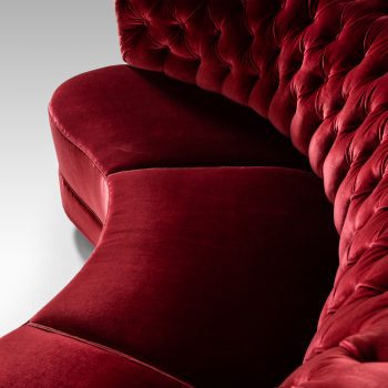 Large freestanding curved sofa in red velvet at Studio Schalling