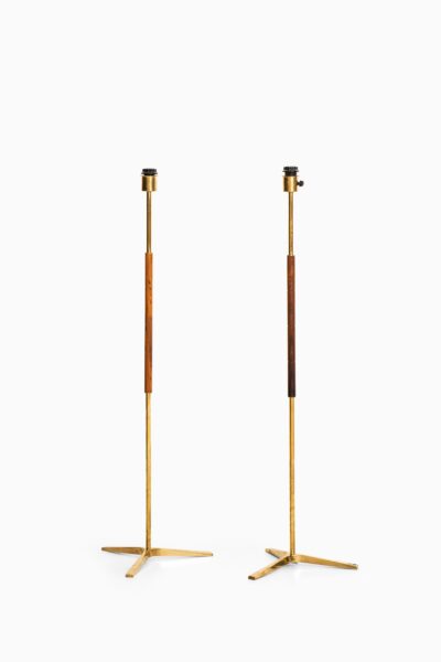 Pair of floor lamps in brass and rosewood at Studio Schalling