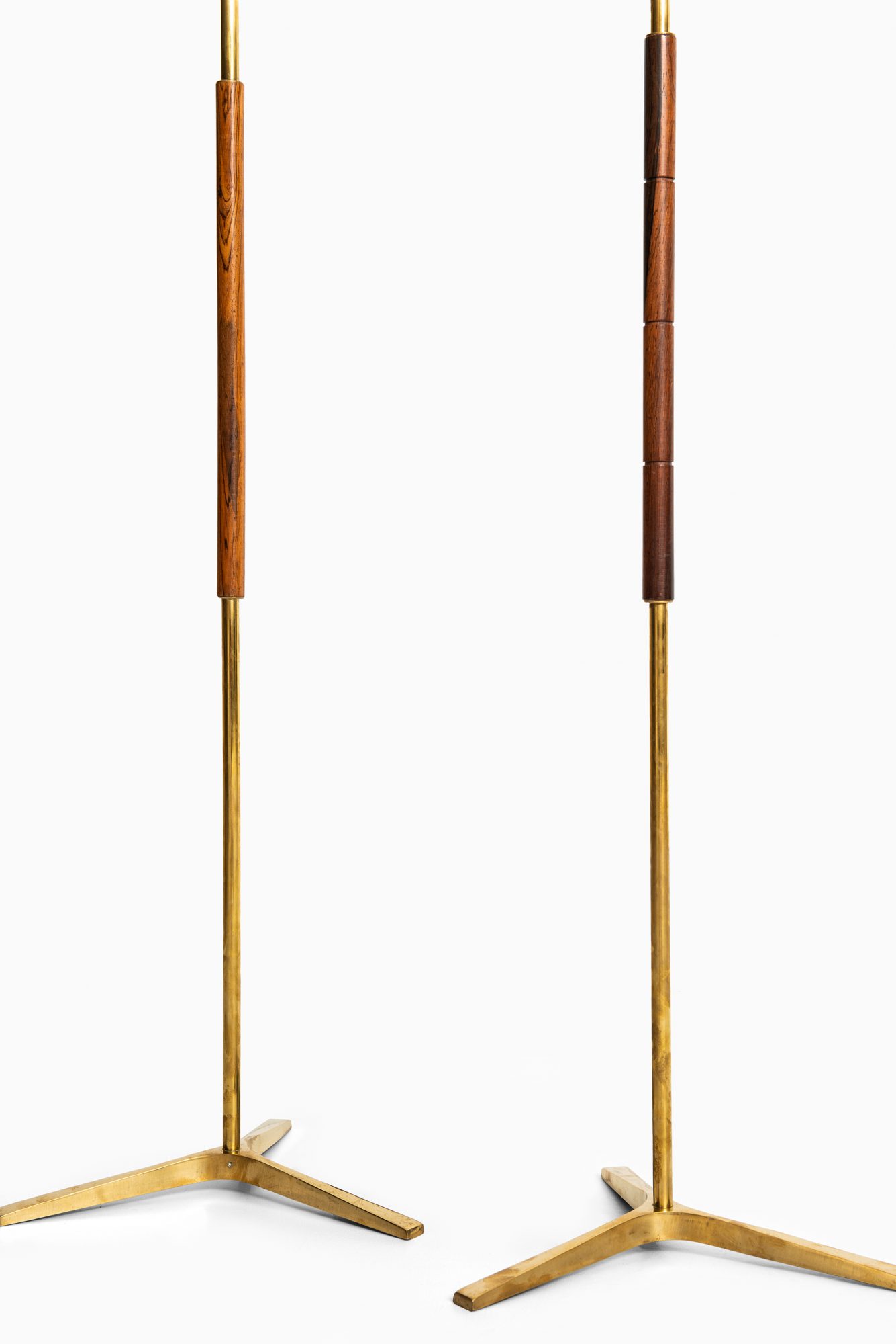 Pair of floor lamps in brass and rosewood at Studio Schalling