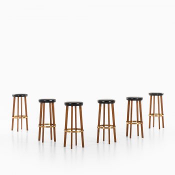 Bar stools in teak and brass at Studio Schalling