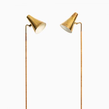 Paavo Tynell floor lamps model K-10 in brass and cane at Studio Schalling