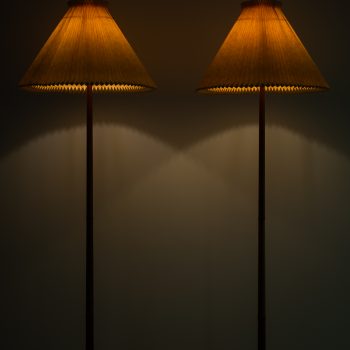 A pair of floor lamps in mahogany at Studio Schalling