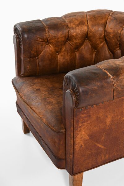 Pair of club easy chairs in patinated leather at Studio Schalling