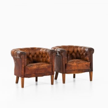 Pair of club easy chairs in patinated leather at Studio Schalling