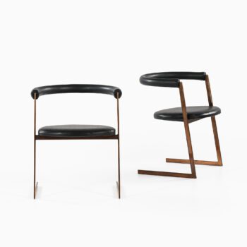 Dining chairs in bronze and black leather at Studio Schalling