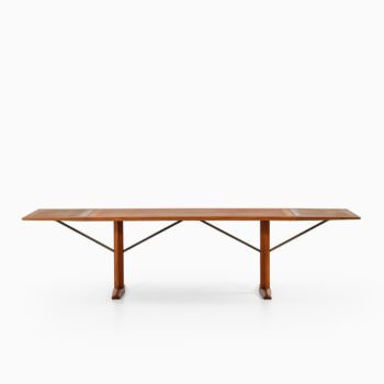 Dining table in teak and brass at Studio Schalling