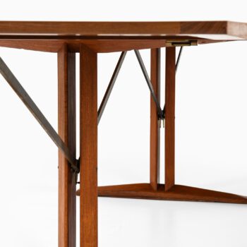 Dining table in teak and brass at Studio Schalling