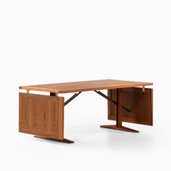 Dining table in teak and brass at Studio Schalling