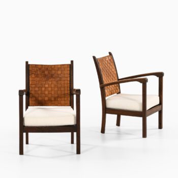Easy chairs in dark stained oak and leather at Studio Schalling