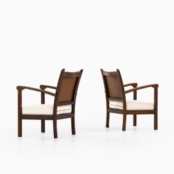 Easy chairs in dark stained oak and leather at Studio Schalling