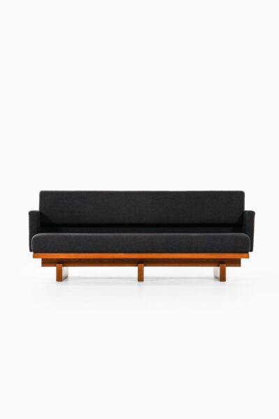 Sofa in mahogany and wool upholstery at Studio Schalling