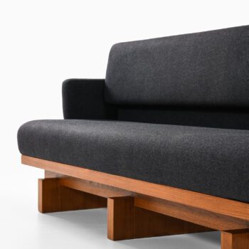 Sofa in mahogany and wool upholstery at Studio Schalling