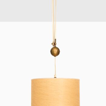 Height adjustable ceiling lamp in brass at Studio Schalling