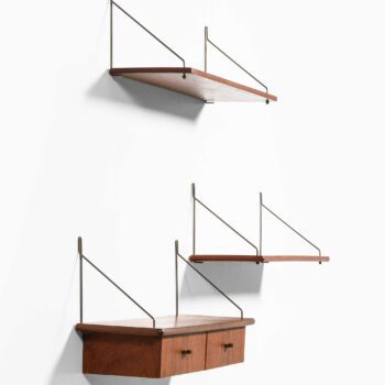 Wall mounted shelves in teak and brass at Studio Schalling