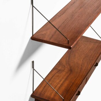 Wall mounted shelves in teak and brass at Studio Schalling