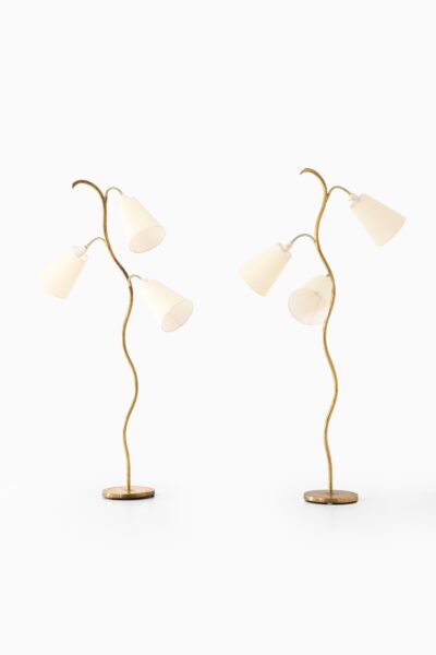 Floor lamps in brass and white lamp shades at Studio Schalling